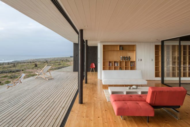 an interior and exterior living space with a red sofa