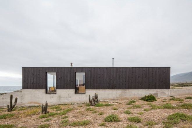 black and gray home on desert landscape