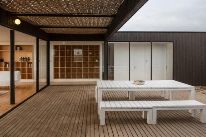 a courtyard with two lounge chairs