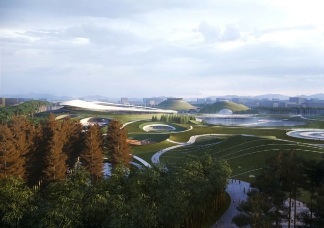 aerial view of rolling green hills with stadiums partially hidden by several trees