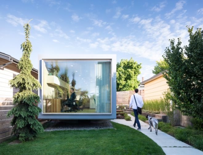 walkway leading up to shipping container office with large window