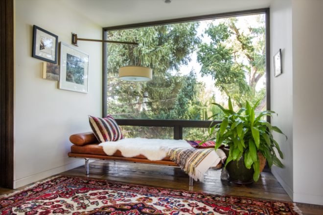 tan leather chaise by a large window