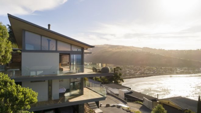 timber home with multiple balconies facing the ocean