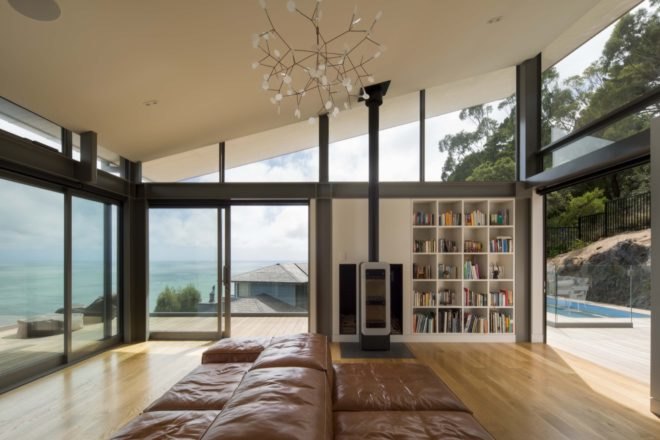 living room with tan leather couch and built-in bookshelves