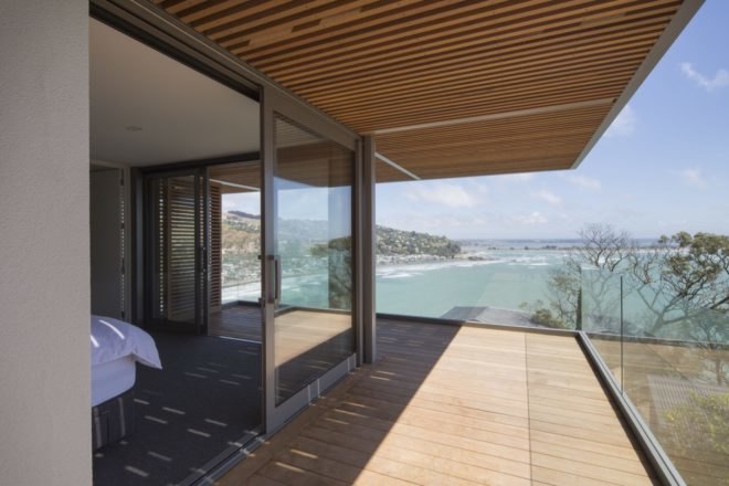 balcony with sliding glass doors facing the ocean