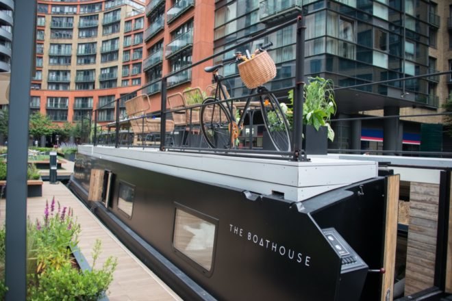 Black canal boat with rooftop deck