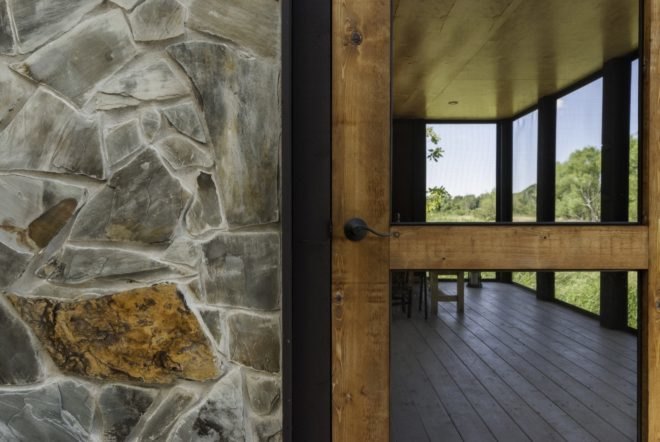close-up of stone wall and a wooden front door