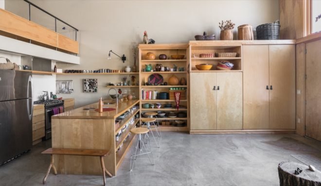 kitchen with light wood island and light wood storage cabinets