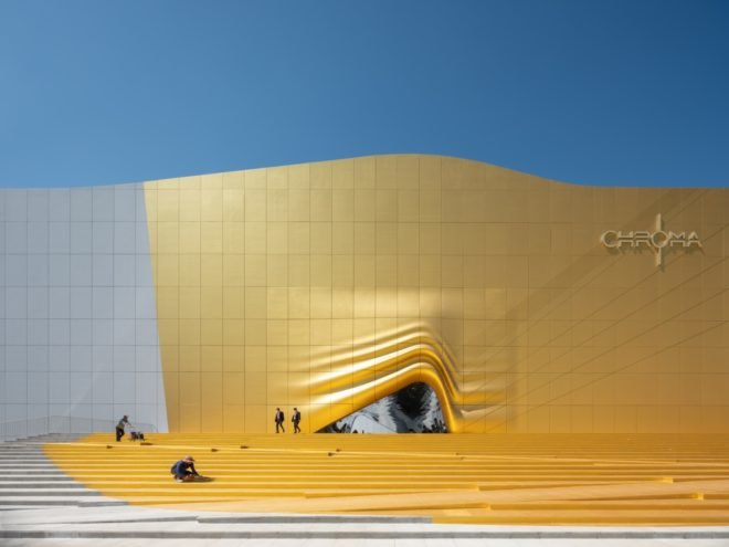 white and gold building with opening that looks like rippled fabric