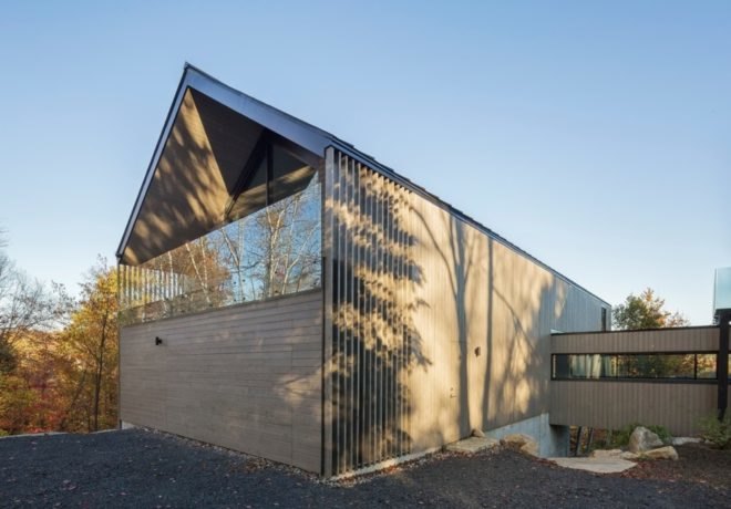 back of timber, gabled structure with narrow passageway leading to another structure