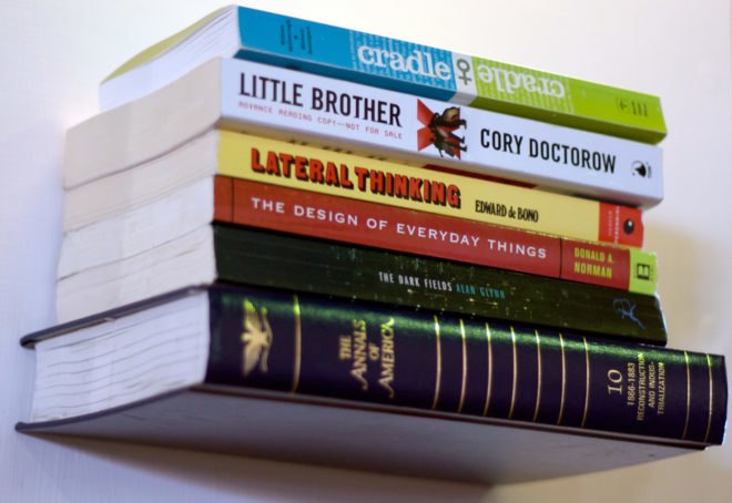 stack of books attached to a wall