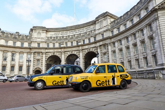 two yellow and black taxis in front of Admiralty Arch in London