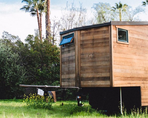 cropped close-up of wooden tiny home with windows