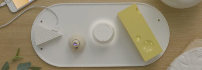 cropped close-up of cheese-shaped chargers and accessories on a white, solar-powered plate