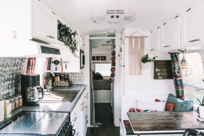 white interior living space with kitchen and dining area