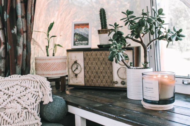 a wooden table with candles and an old radio