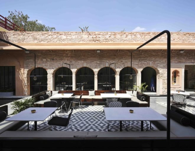 dining area with stone walls and black and white furnishings