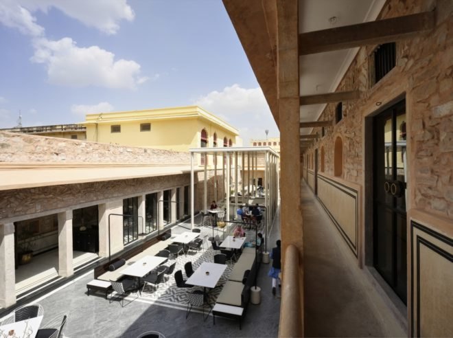 open-air dining area with restored stone walls
