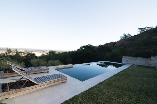 wood lounge chairs near a pool