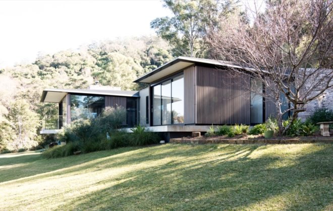 timber-clad home with large glass windows