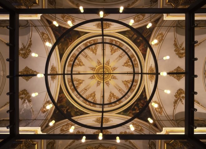 view up toward ornate, gold ceiling of a dome