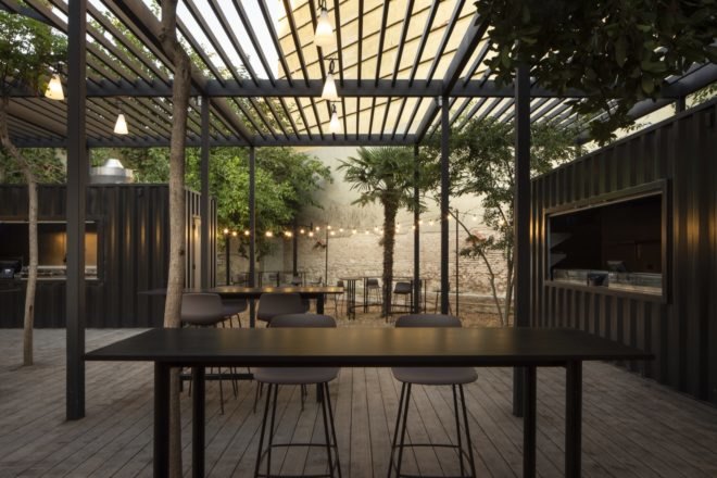 outdoor dining area with trees and twinkle lights