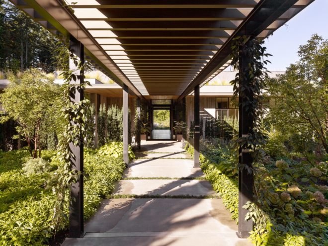 long covered walkway with plants on each side