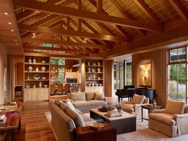 timber-lined living room with tall wood shelves and exposed wood ceiling beams