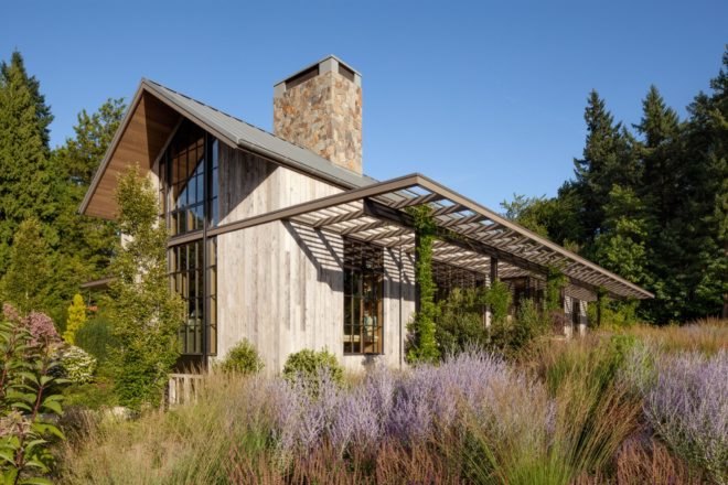 timber gabled home surrounded by purple and green plants