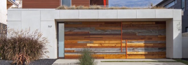 white home with different colors of wood planks on the front facade