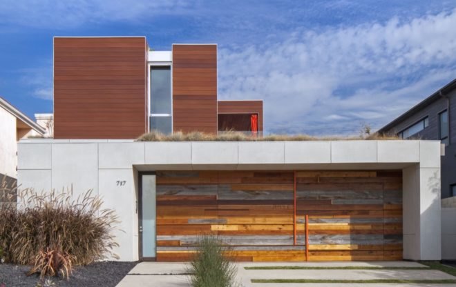 white home with different colors of wood planks on the front facade