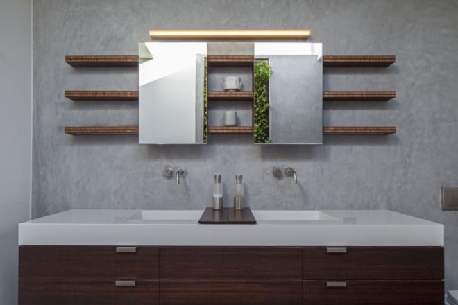 bathroom with wood cabinets, white countertop and open wood shelves