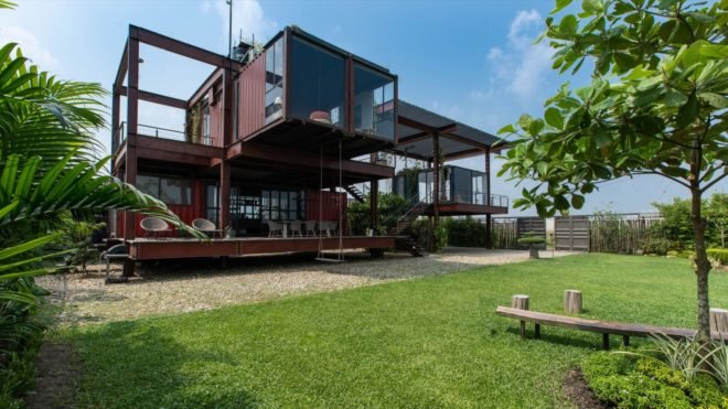 red home made from several stacked shipping containers