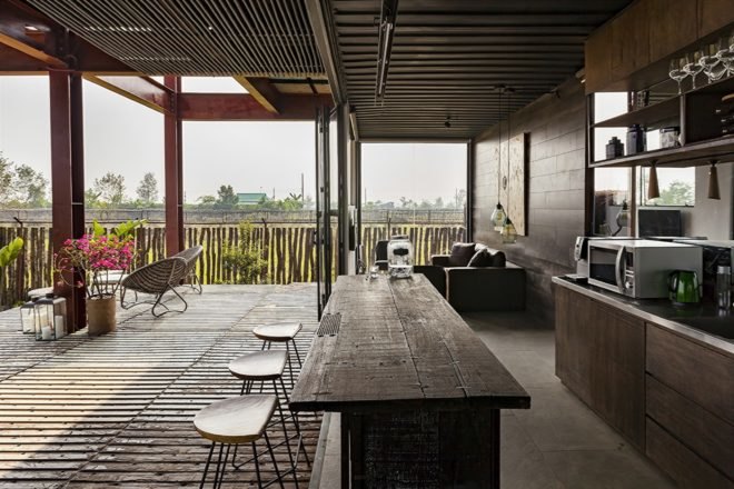 wood cabinets and island of outdoor kitchen