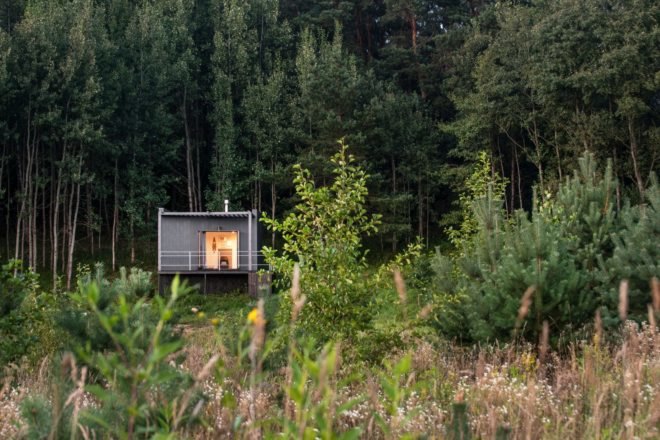black hut surrounded by greenery