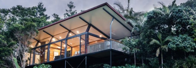 cropped close-up of elevated glass cabin surrounded by trees