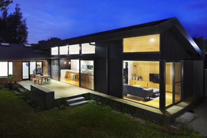 black timber extension of a brick mid-century home
