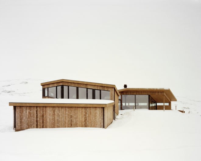 a light wood cabin with glass walls