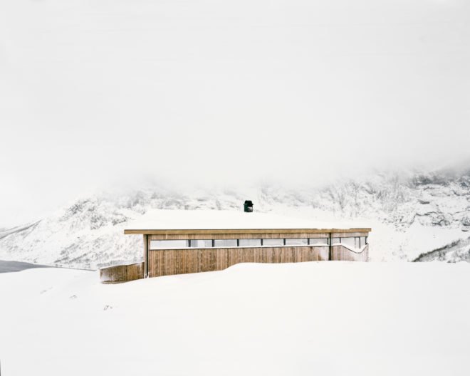 wooden cabin on snowy hill