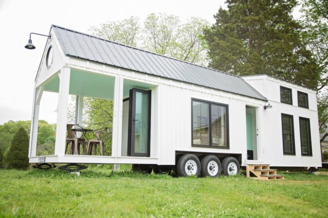 white tiny home with large covered porch