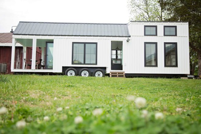 extended white tiny home on wheels