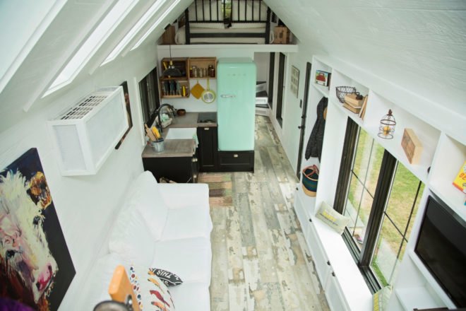aerial view of tiny home with white walls and kitchen with blue SMEG fridge