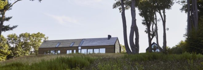 cropped close-up of long timber home with gabled roof