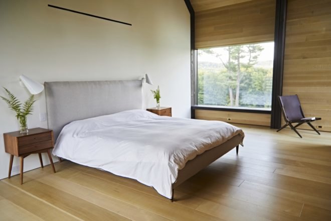 bedroom with timber walls and floors and large window