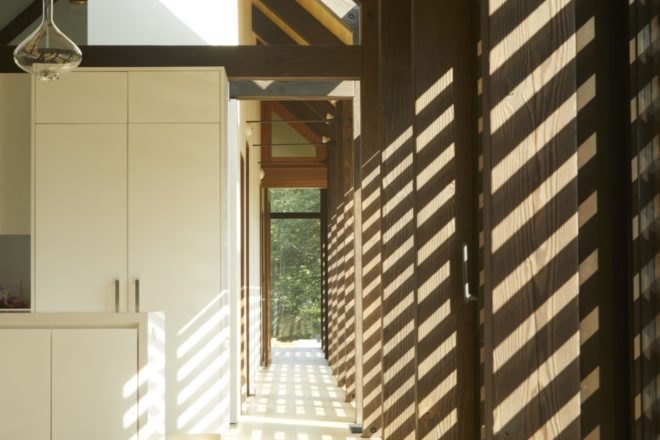 hallway with timber walls and exposed wood ceiling beams