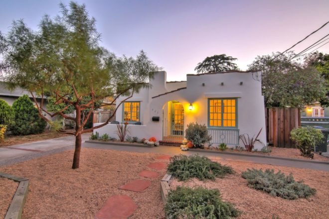 white bungalow with tree in front yard