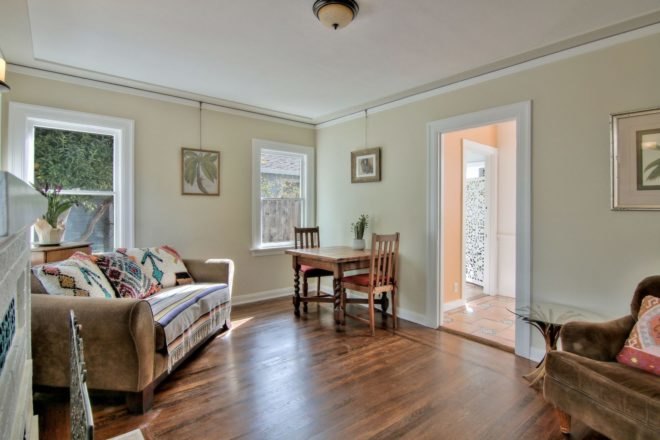 tan living room with sofa and wood floors