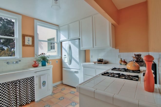 kitchen with orange walls and white ceramic countertops