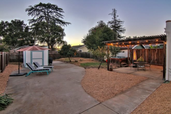 backyard with pergola and lounge chairs