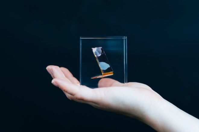 person holding glass cube